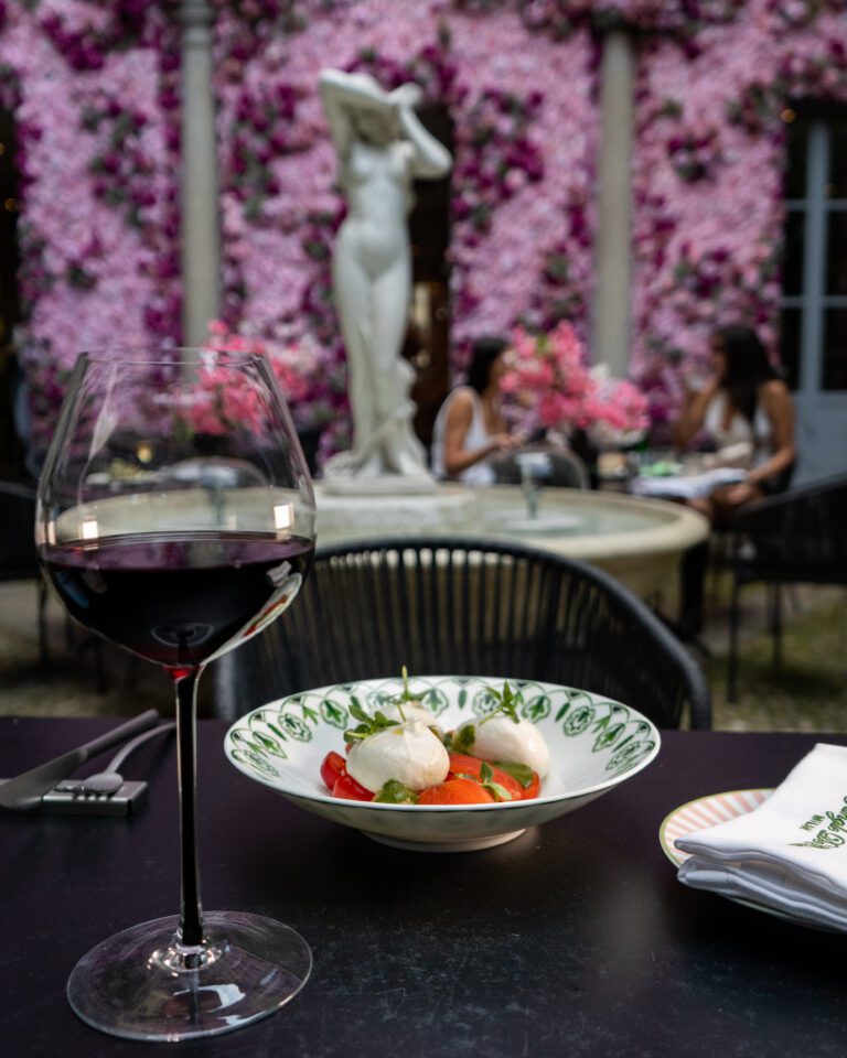 Chef’s plating with white wine on a patio table